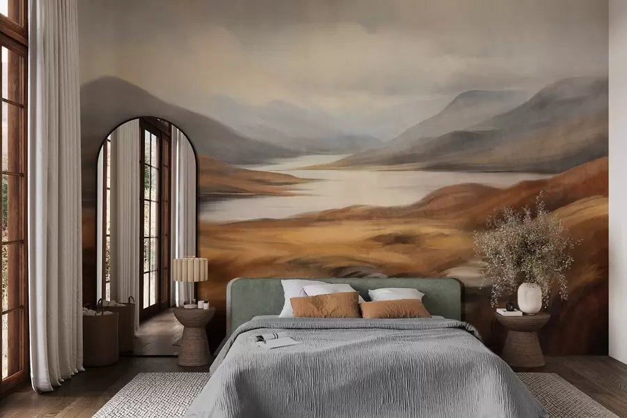 Carta da parati nature Paesaggio variegato, con un lago circondato da colline e montagne sotto un cielo nuvoloso e erba secca 